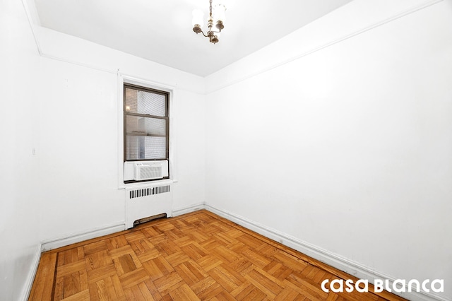 687 W 204th St Unit 1-E, New York City, NY 10034 - empty room with radiator, baseboards, a chandelier, and cooling unit