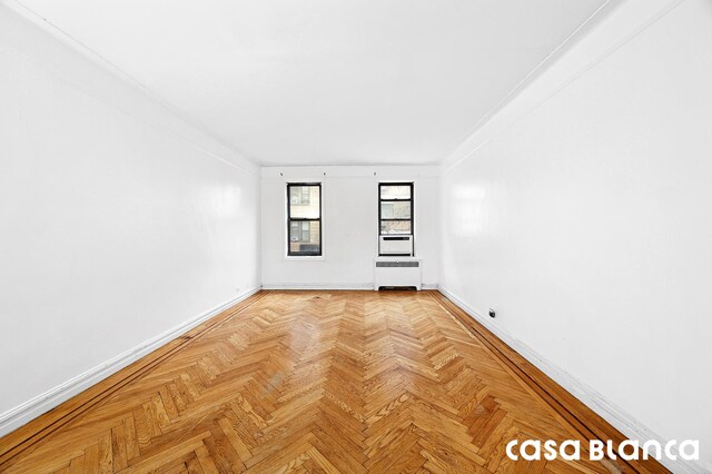 unfurnished room with baseboards and ornamental molding