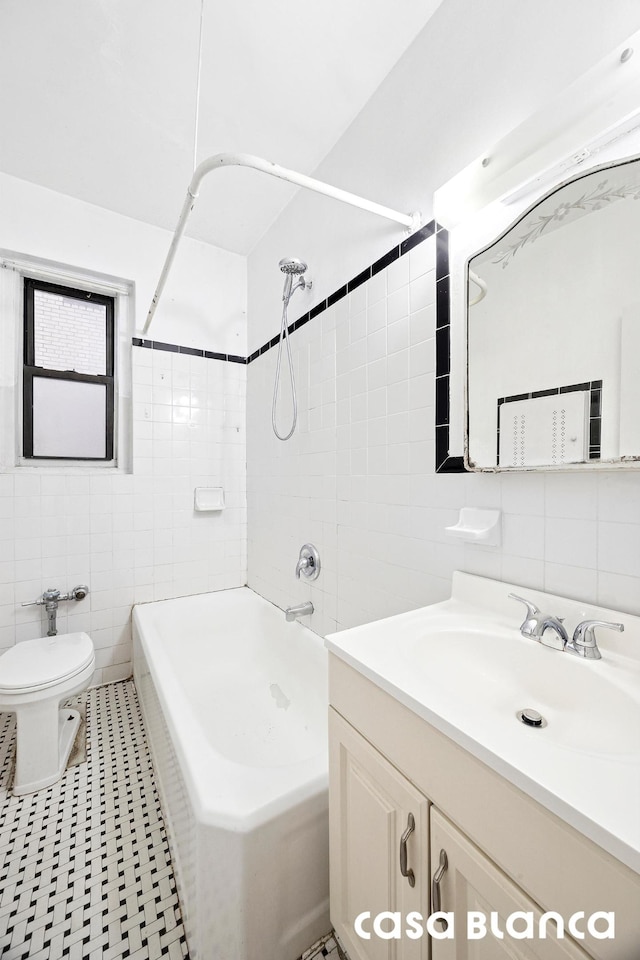687 W 204th St Unit 1-E, New York City, NY 10034 - full bath featuring tile walls, vanity, toilet, and shower / bathtub combination