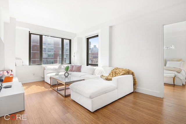 305 W 16th St Unit 4E, New York City, NY 10011 - living room featuring light wood finished floors and baseboards
