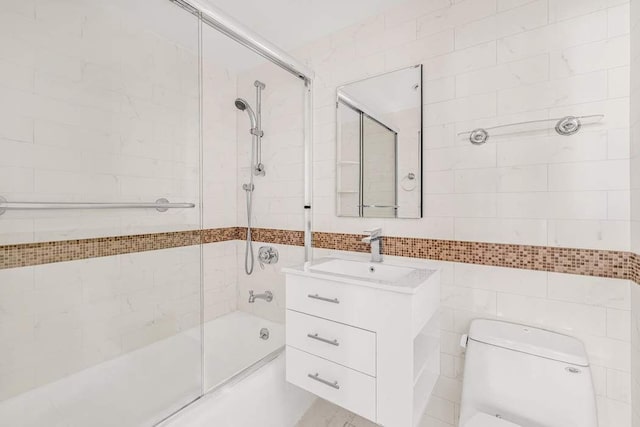 169 E 69th St Unit 19A, New York City, NY 10021 - full bathroom featuring vanity, enclosed tub / shower combo, toilet, and tile walls