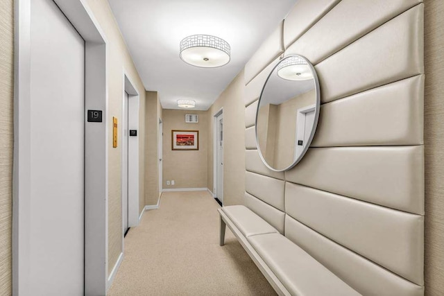 169 E 69th St Unit 19A, New York City, NY 10021 - corridor with elevator, light carpet, and baseboards