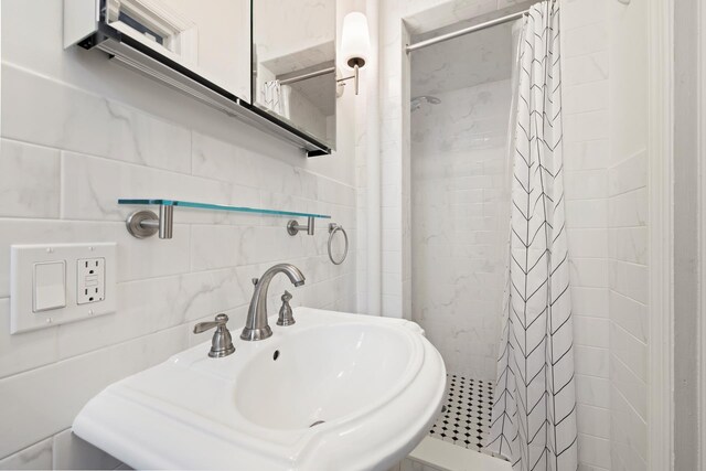 86-10 34th Ave Unit 113, New York City, NY 11372 - full bath with a sink, a stall shower, and tile walls