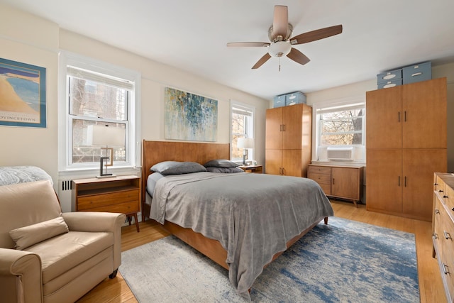 86-10 34th Ave Unit 113, New York City, NY 11372 - bedroom featuring radiator, light wood-style flooring, ceiling fan, and cooling unit