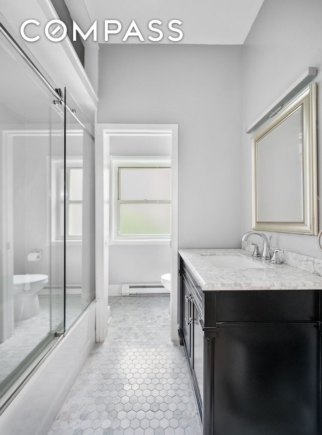 57 E 73rd St Unit 1/2, New York City, NY 10021 - bathroom featuring toilet, a baseboard radiator, vanity, and combined bath / shower with glass door