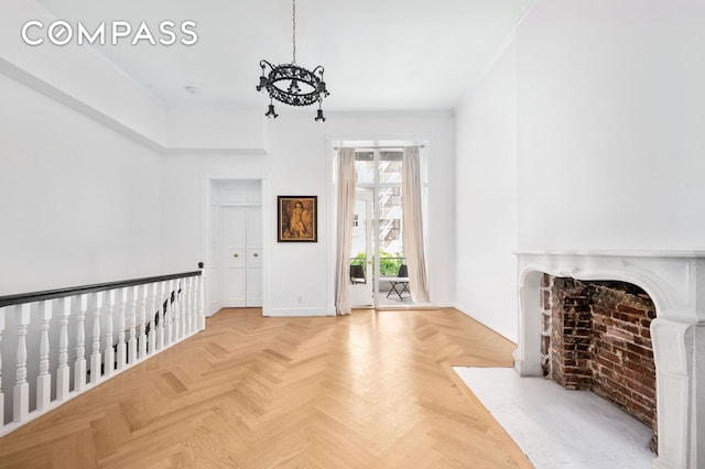 57 E 73rd St Unit 1/2, New York City, NY 10021 - unfurnished living room featuring a chandelier, baseboards, and a fireplace with flush hearth