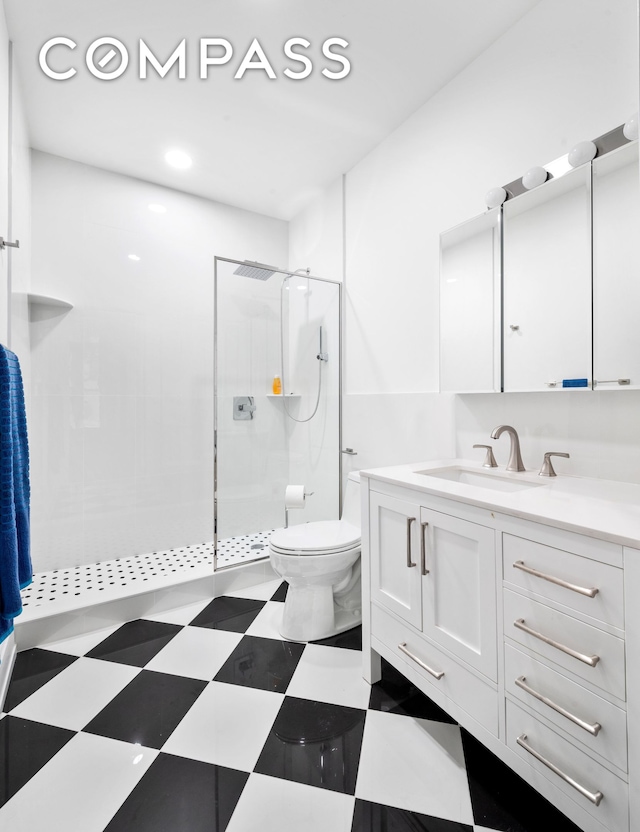 full bathroom featuring tile patterned floors, toilet, walk in shower, and vanity