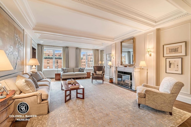 living room with crown molding, a high end fireplace, a decorative wall, beam ceiling, and wood finished floors