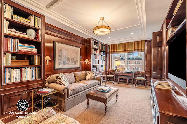 living area with a desk, crown molding, and carpet flooring
