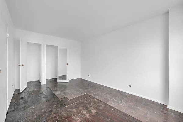 345 E 80th St Unit 28-C, New York City, NY 10075 - spare room featuring baseboards