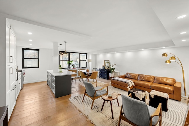 235 E 57th St Unit 8F, New York City, NY 10022 - living area with recessed lighting, light wood finished floors, and baseboards