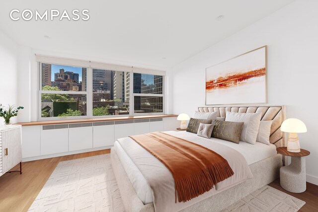 221 E 50th St Unit 6D/7D, New York City, NY 10022 - bedroom featuring light wood-type flooring and a city view