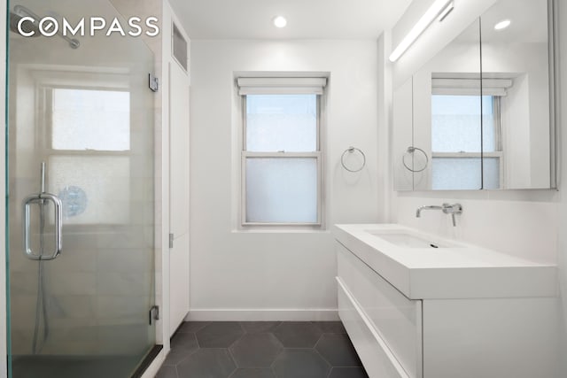 full bath featuring plenty of natural light, visible vents, tile patterned flooring, a stall shower, and vanity