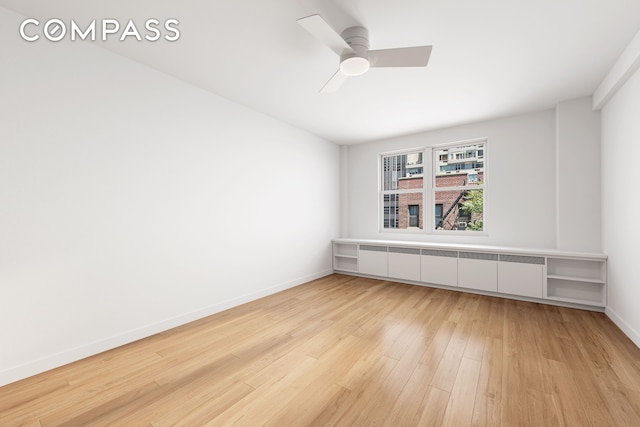 221 E 50th St Unit 6D/7D, New York City, NY 10022 - empty room featuring light wood-style floors, ceiling fan, and radiator heating unit