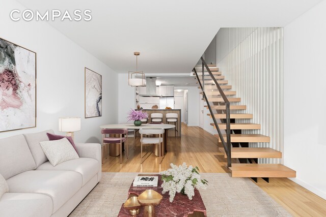 221 E 50th St Unit 6D/7D, New York City, NY 10022 - living area featuring stairway, light wood finished floors, and baseboards