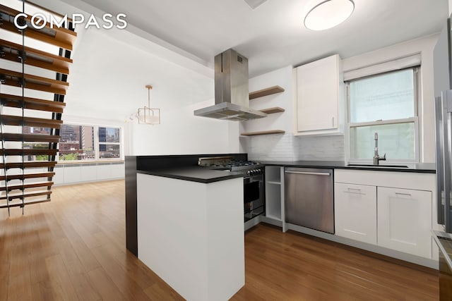 kitchen featuring dark countertops, open shelves, a sink, stainless steel appliances, and island range hood