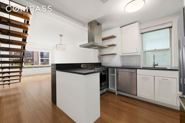 221 E 50th St Unit 6D/7D, New York City, NY 10022 - kitchen featuring island range hood, stainless steel appliances, dark countertops, open shelves, and a sink