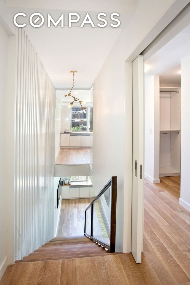 221 E 50th St Unit 6D/7D, New York City, NY 10022 - stairs featuring wood finished floors