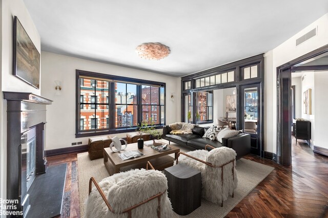 211 Elizabeth St Unit 5N, New York City, NY 10012 - living area featuring baseboards and a glass covered fireplace