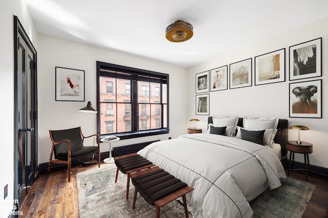 211 Elizabeth St Unit 5N, New York City, NY 10012 - bedroom featuring dark wood finished floors and baseboards