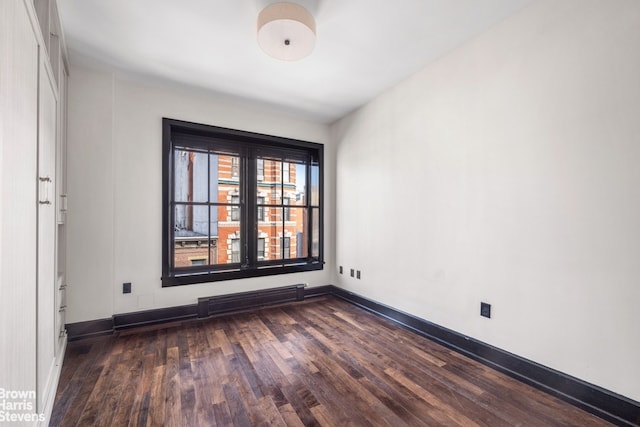211 Elizabeth St Unit 5N, New York City, NY 10012 - unfurnished room featuring dark wood-type flooring and baseboards