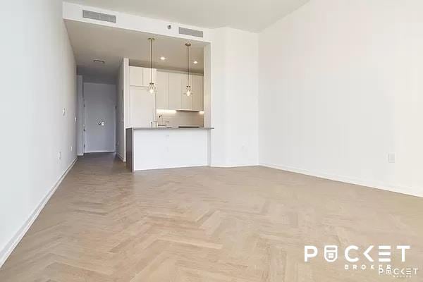 184 Kent Ave Unit C-614, New York City, NY 11249 - unfurnished living room with baseboards