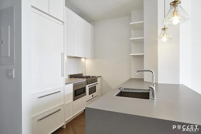 184 Kent Ave Unit C-614, New York City, NY 11249 - kitchen featuring a sink, white cabinets, open shelves, backsplash, and hanging light fixtures