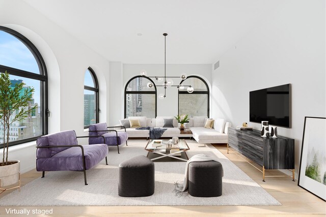 130 William St Unit 38D, New York City, NY 10038 - living area featuring a chandelier and light wood-style flooring