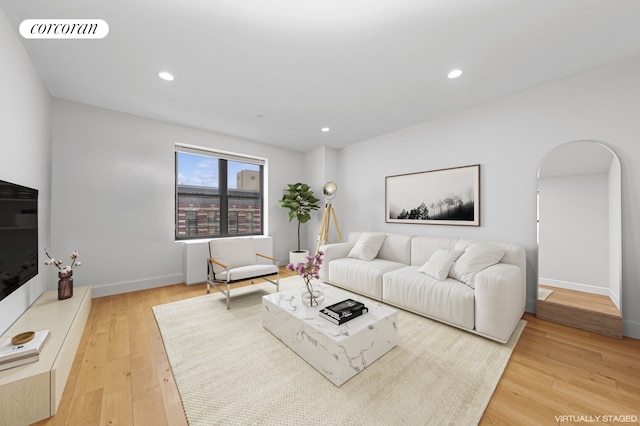 234 W 148th St Unit 5E, New York City, NY 10039 - living area with arched walkways, light wood finished floors, baseboards, and recessed lighting