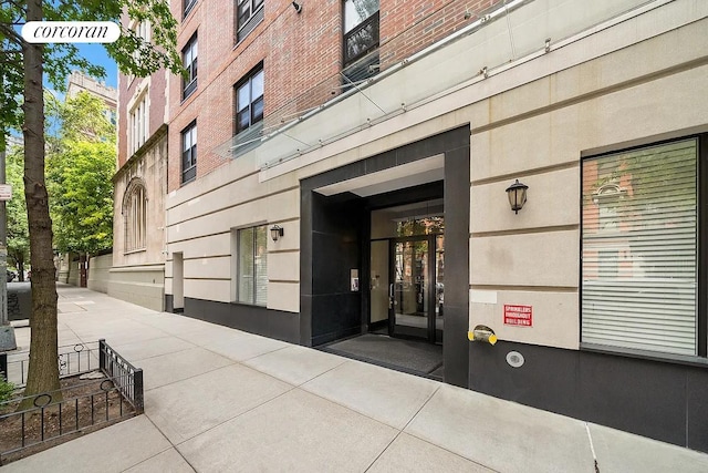 property entrance featuring brick siding