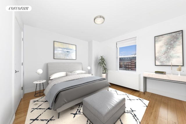 bedroom with wood finished floors and baseboards