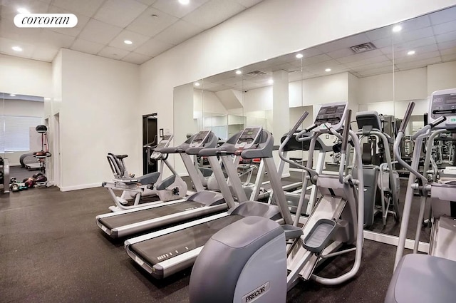 workout area featuring a drop ceiling and recessed lighting