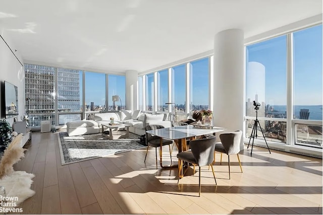 15 Hudson Yards Unit 63A, New York City, NY 10001 - dining area featuring floor to ceiling windows, wood-type flooring, and a city view