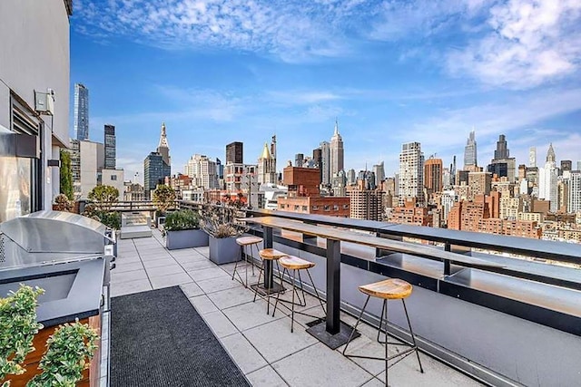 balcony with grilling area and a city view
