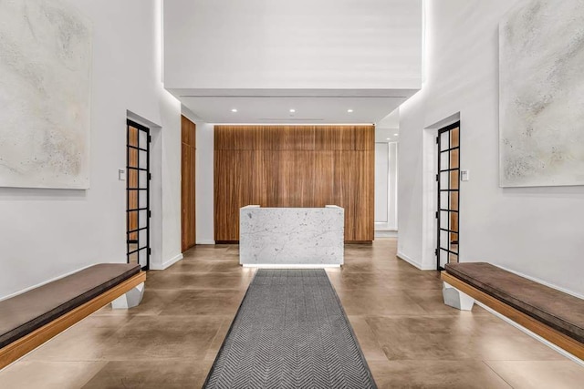 foyer entrance with recessed lighting, baseboards, and finished concrete floors