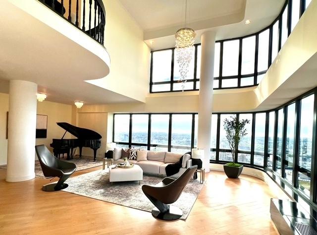 530 E 76th St Unit Ph35H36H, New York City, NY 10021 - living area with a water view, a high ceiling, and a wealth of natural light