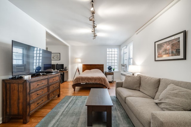 54 E 8th St Unit 6-L, New York City, NY 10003 - bedroom featuring light wood-style floors, track lighting, and an office area