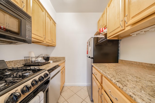 54 E 8th St Unit 6-L, New York City, NY 10003 - kitchen featuring appliances with stainless steel finishes, light brown cabinetry, light tile patterned floors, and light stone countertops