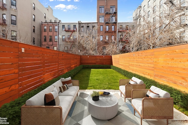 view of yard with a patio, an outdoor living space, and a fenced backyard
