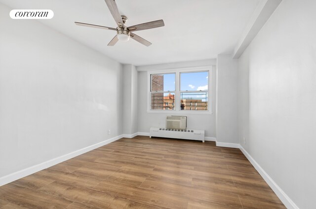 1655 Flatbush Ave Unit A602, New York City, NY 11210 - unfurnished room featuring a baseboard heating unit, a ceiling fan, wood finished floors, baseboards, and an AC wall unit