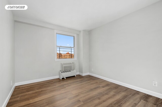 1655 Flatbush Ave Unit A602, New York City, NY 11210 - unfurnished room featuring wood finished floors, baseboards, and a wall mounted air conditioner