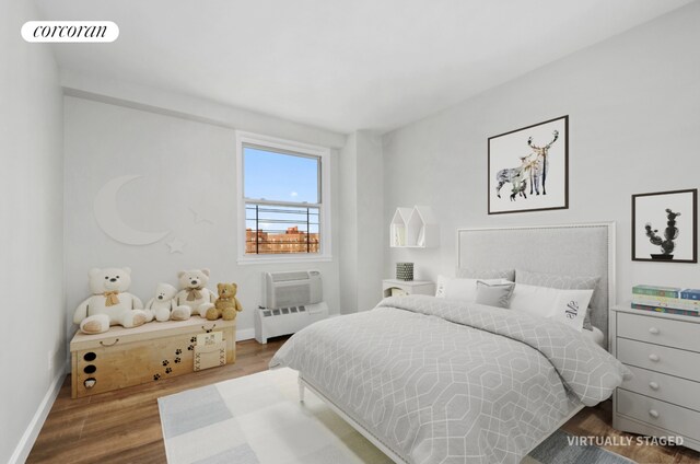 1655 Flatbush Ave Unit A602, New York City, NY 11210 - bedroom with baseboards, wood finished floors, radiator, and a wall mounted AC