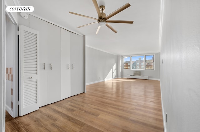 1655 Flatbush Ave Unit A602, New York City, NY 11210 - unfurnished bedroom with wood finished floors, a closet, a baseboard radiator, ornamental molding, and a ceiling fan