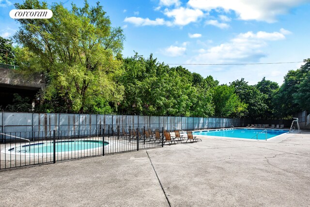 1655 Flatbush Ave Unit A602, New York City, NY 11210 - community pool featuring fence, a patio area, and view of scattered trees