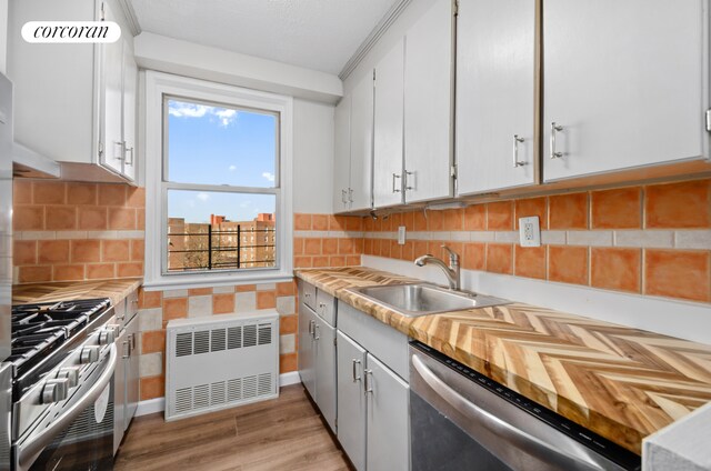 1655 Flatbush Ave Unit A602, New York City, NY 11210 - kitchen featuring radiator, stainless steel appliances, a sink, and light countertops