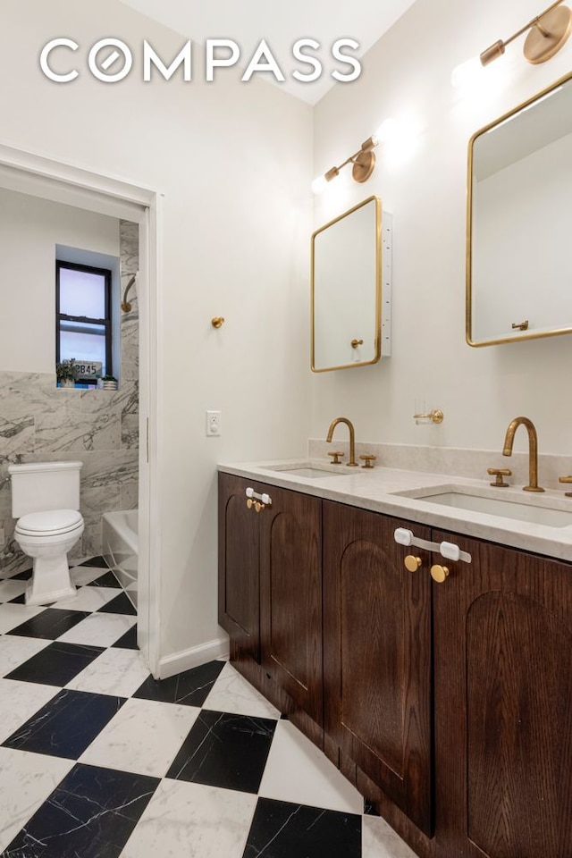 31 Tiemann Pl Unit 37, New York City, NY 10027 - full bath featuring toilet, tile walls, double vanity, and shower / washtub combination