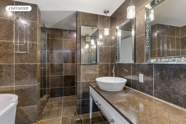340 E 23rd St Unit 9A, New York City, NY 10010 - full bath with tile walls, tiled shower, vanity, and tile patterned floors