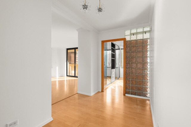 311 E 38th St Unit 7B, New York City, NY 10016 - hall with wood finished floors, ornamental molding, and a healthy amount of sunlight