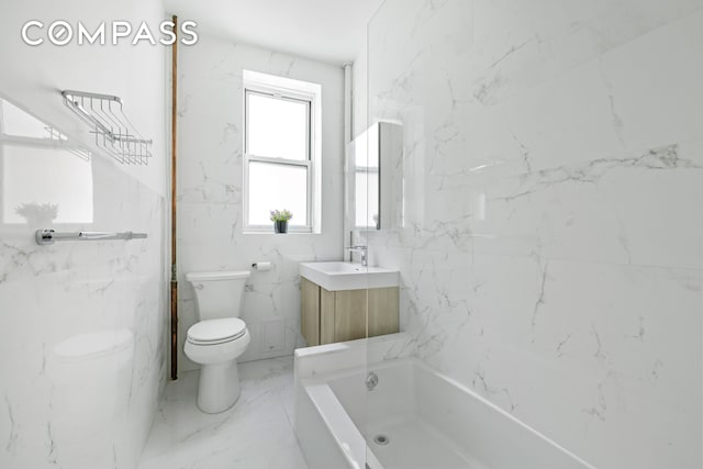 full bath featuring a tub, toilet, marble finish floor, and vanity