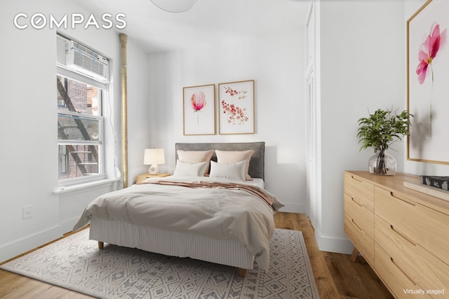 bedroom featuring baseboards and wood finished floors